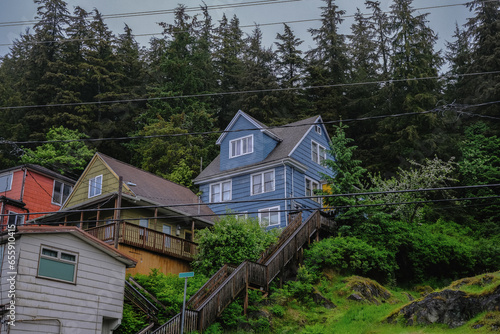 Street city view with wooden houses  shops  cars and mountain wilderness nature in Ketchikan  Alaska  popular cruise destination for whale watching in wildlife tours