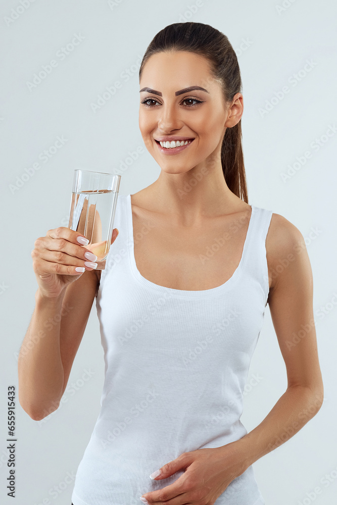 Beautiful woman holding water glass. Drink water. Girl with glass of water. Diet concept Beautiful woman holding water glass. Drink water. Girl with glass of water. Diet concept