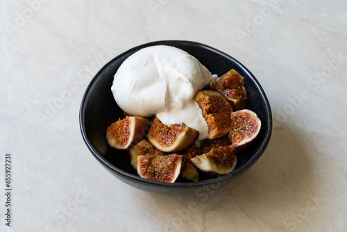 Fig with Burrata Cheese served in Plate.