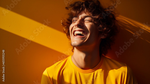 french male model laughing in yellow clothes