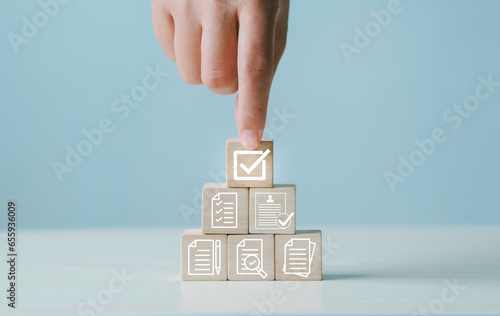Certificate icon on wooden cube, and quality certification concept, International Organization for Standardization ISO, symbol of leading service quality assurance photo