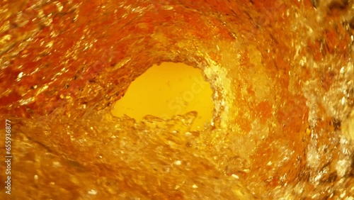 Super Slow Motion Shot of Whisky or Cider Vortex at 1000 fps. photo