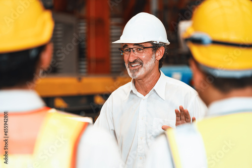 Collective factory worker and engineer gather for meeting with factory executive or manager, discussing plan and industry training program on-site work heavy industrial steel workshop. Exemplifying