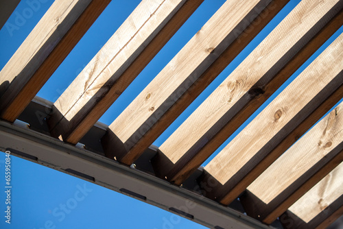 wooden roof of the gazebo overlooking the sky