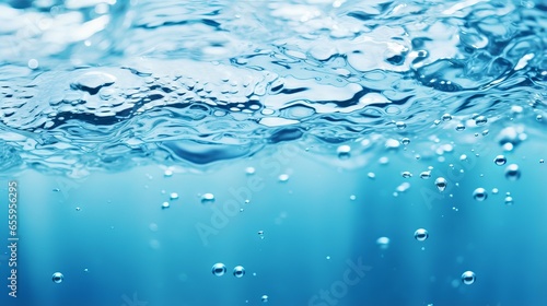 Blurred blue water surface with ripples and bubbles