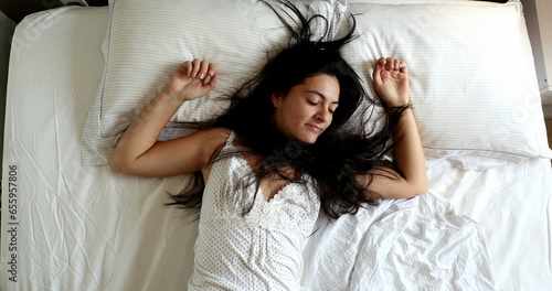 Lazy woman lying in bed in the morning wanting to sleep and stay in bed