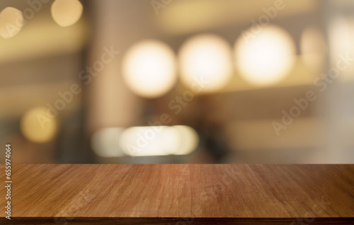 Mock up for space. Empty dark wooden table in front of abstract blurred bokeh background of restaurant . can be used for display or montage your product © Charlie's
