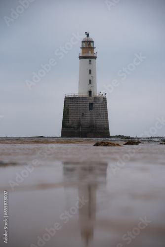 Rattray Head lighthouse in scottish highlands. North coast 500. Calm coastline with nobody.  photo