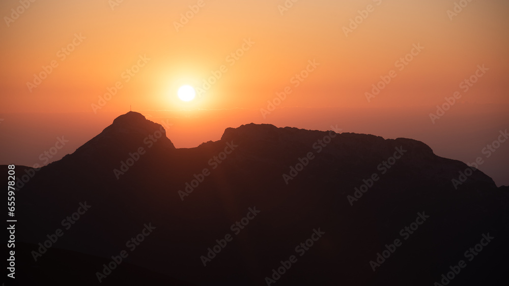 Sunset in High Tatras from Poland side. Amaizing scenery from top of the mountains. You can see Poland and Slovakia countryside meet a chamonix and enjoy hike. Iconic peak is Wielki Giewont. - obrazy, fototapety, plakaty 