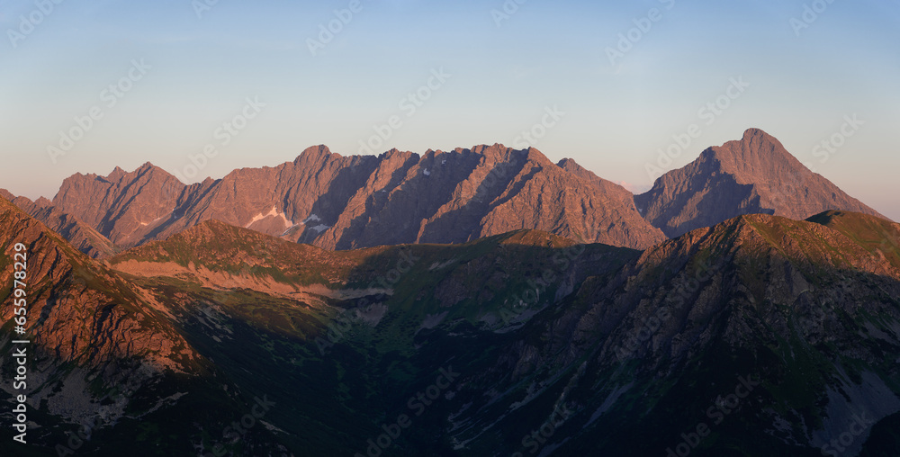 Sunset in High Tatras from Poland side. Amaizing scenery from top of the mountains. You can see Poland and Slovakia countryside meet a chamonix and enjoy hike. Iconic peak is Wielki Giewont. - obrazy, fototapety, plakaty 