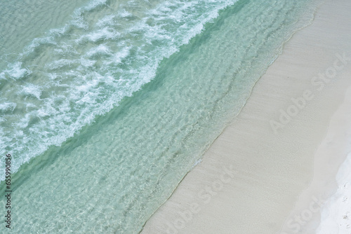 Aerial view Destin, Florida, white sand beach on a bright sunny day on the Gulf of Mexico clear emerald waters 