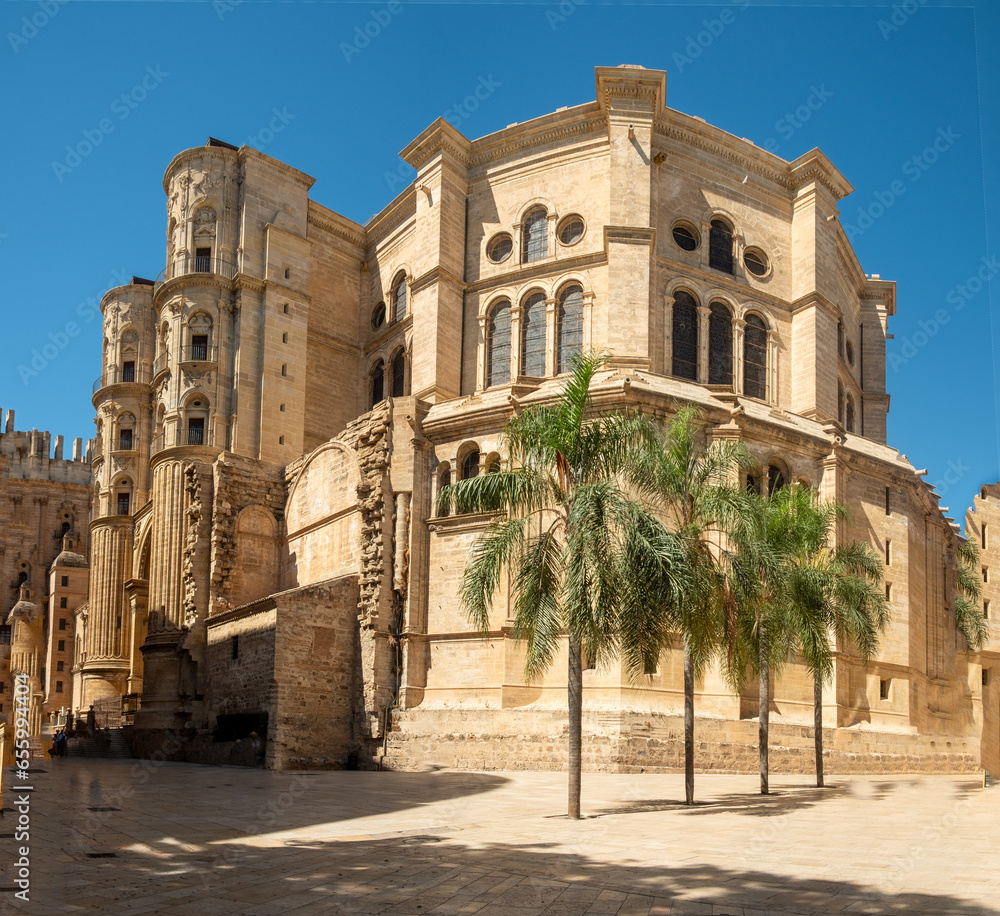 the Royal Monastery of San Jerónimo from Calle Compás de San Jerónimo on a sunny day with clear skies in Malaga, Spain