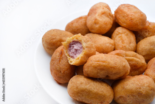 Sausages in dough on a white plate. Delicious meat appetizer in batter.