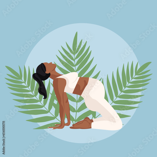 black pregnant girl in a white suit doing yoga on a blue background
