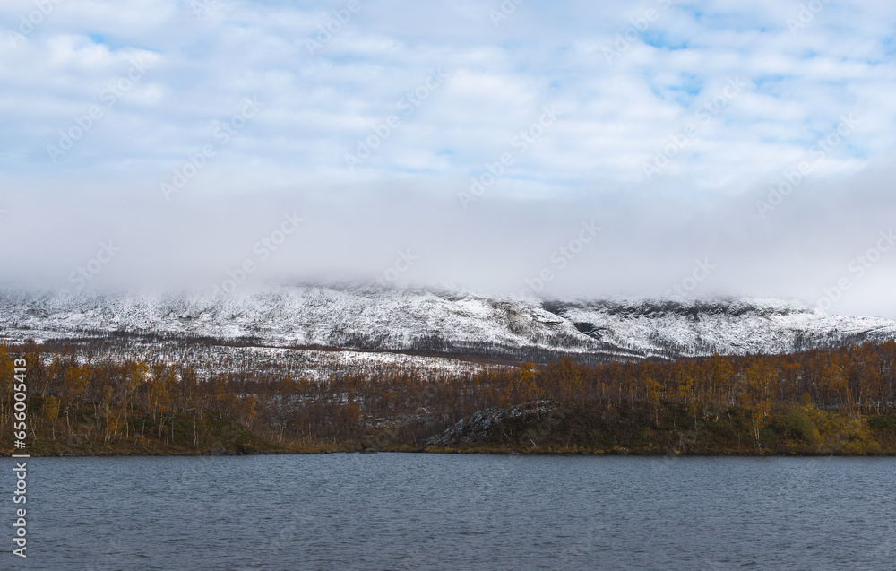 Beautiful autumn landscape with lake and mountains in Finnish Lapland
