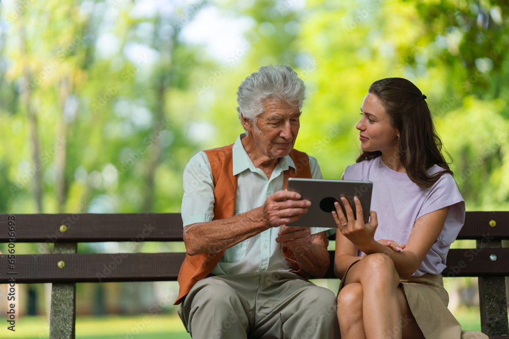 Caregiver helping senior man to shop online on tablet. Caregiver helping senior man to shop online on tablet.