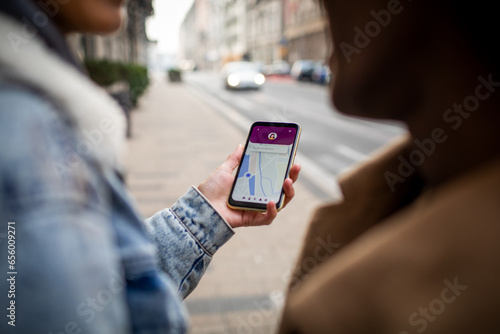 Close up of a young woman using her smartphone to navigate through the city