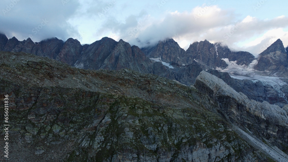 Aerial drone view of majestic Switzerland Alps with huge glaciers. Steep rocky peaks of Piz Bernina mountain range
