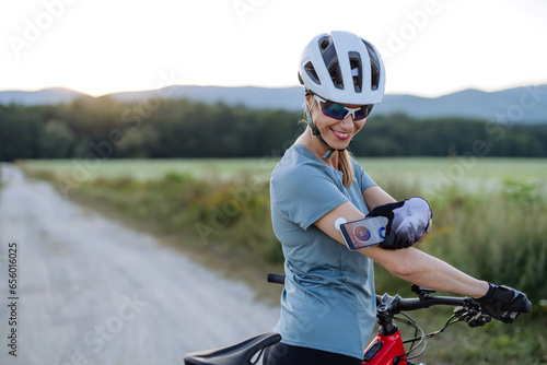 Diabetic cyclist connecting continuous glucose monitor with her smartphone to monitor her blood sugar levels in real time.