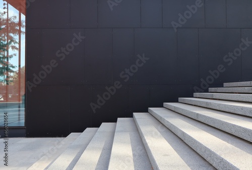 The black wall of the building and light stairs