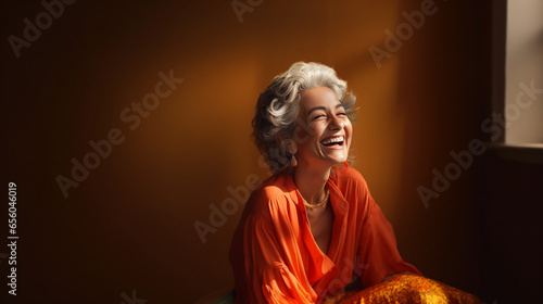 portrait of an elderly grandmother laughing in a studio