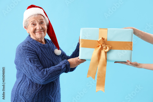 Happy senior woman in santa...