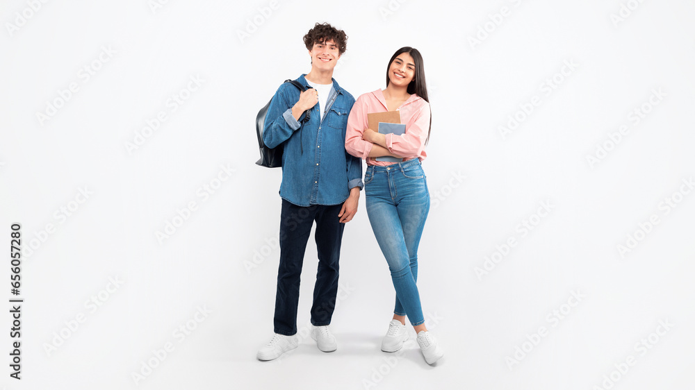 Cheerful Young Students Duo Standing With Backpacks Over White Background Cheerful Young Students Duo Standing With Backpacks Over White Background