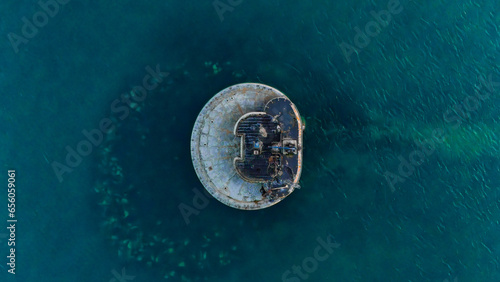 Captivating top-down view of a sea fort amid azure waters, revealing submerged rocks below © phillip
