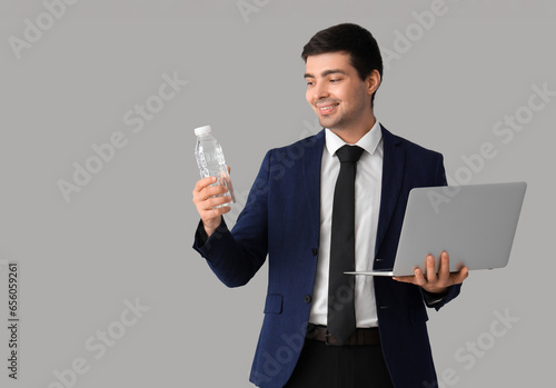 Young businessman with bott...