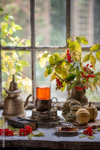 Still life with sea buckthorn and viburnum. autumn healthy tea. Autumn naturmort with tea and honey.