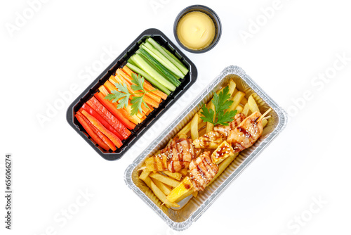 chicken skewers with pineapple, French fries, bell pepper, carrots, cucumber, cheese sauce
 on a white background, studio shot