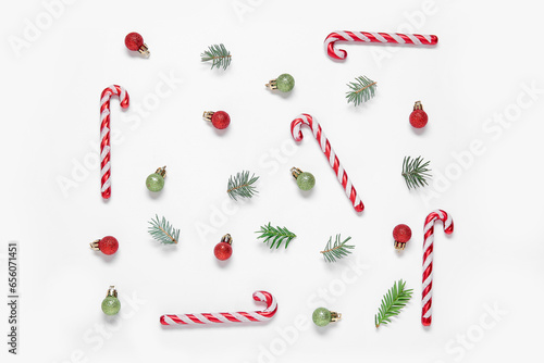 Beautiful composition with Christmas decorations and candy canes on white background