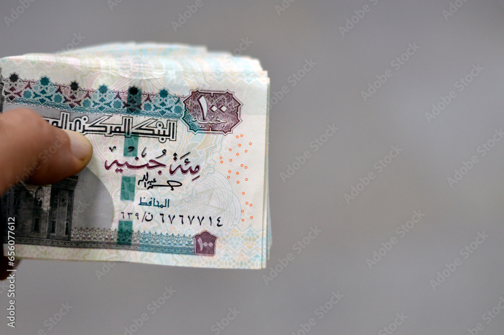 Folded 100 EGP LE one hundred Egyptian pounds cash money bills rolled ...
