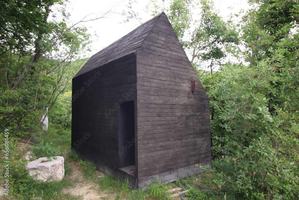 black wooden house on the mountains among nature in Botticino in Brescia in Italy