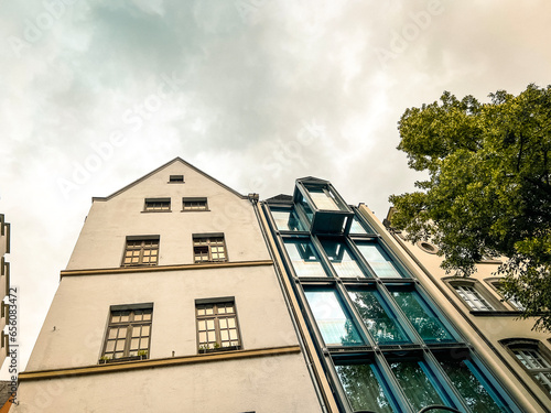 Fotografie Looking up at contrasting traditional and modern architecture in Cologne, Germany