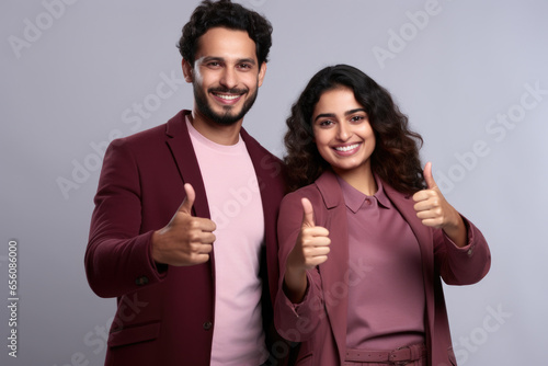 Picture of man and woman showing their approval by giving thumbs up. Suitable for illustrating positive feedback and agreement in various contexts.