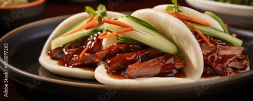 An angled shot showcasing a Bao bun filled with tender and juicy slices of roasted duck, accompanied by a subtly sweet hoisin sauce, inviting a harmonious combination of flavors. photo