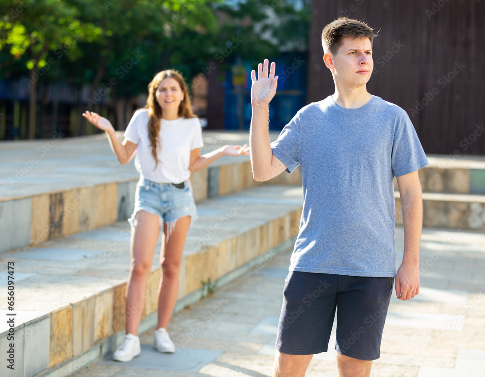 Fototapeta premium Guy was offended by the girl after quarrel on the street