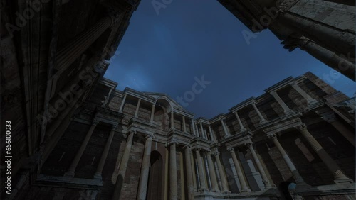 Sardes of Manisa Turkey with time lapse of night stars and gymnasium building photo