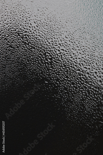 water drops on the transparent surface of a glass bottle , condensation