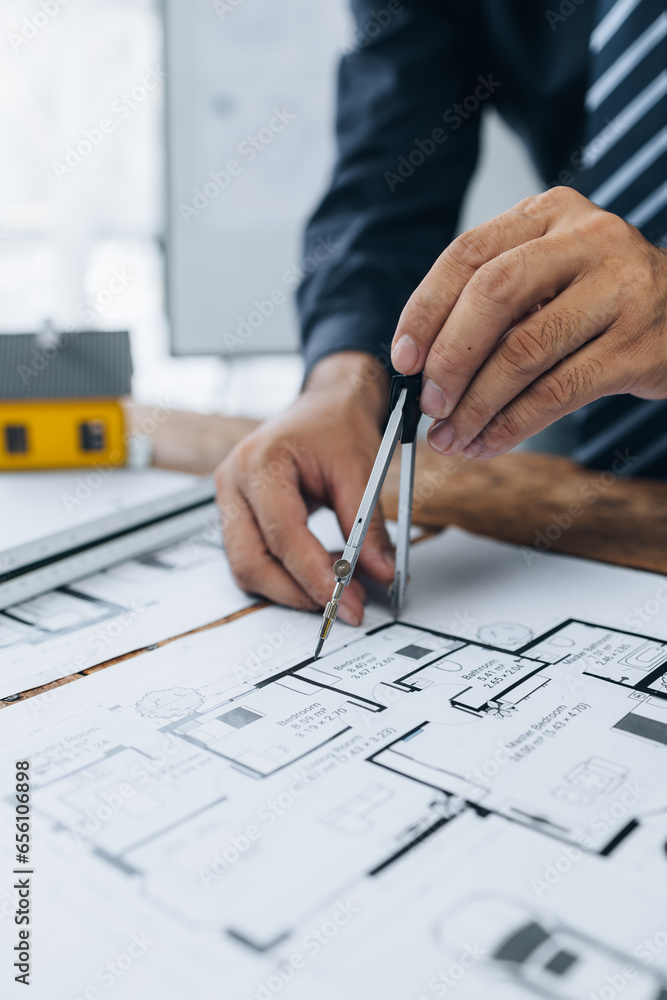 Architects sketch and edit real estate building plans, design buildings according to standards and plan structures, draw professional floor plans. Real estate design and construction concepts. Architects sketch and edit real estate building plans, design buildings according to standards and plan structures, draw professional floor plans. Real estate design and construction concepts.