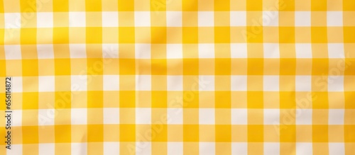 Top view of a picnic tablecloth with yellow checkered pattern et as a backdrop photo