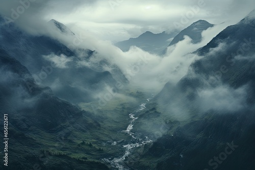 a valley with clouds and mountains
