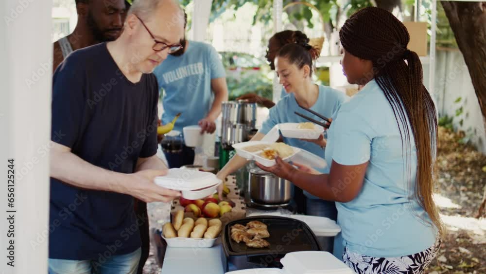 Non-profit group dedicates itself to hunger relief by giving free food to homeless people. Volunteers serving meals to individuals from various backgrounds, fostering a sense of community and support. Non-profit group dedicates itself to hunger relief by giving free food to homeless people. Volunteers serving meals to individuals from various backgrounds, fostering a sense of community and support.