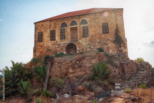 View of the old traditional Lebanese stone house over the Mediterranean sea in Byblos, Lebanon. The house is part of the ancient archaeological complex located next to it. photo