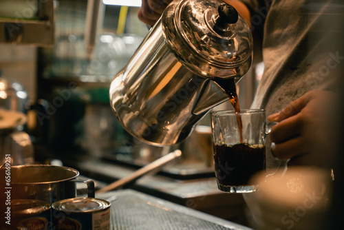 kopitiam worker pour perfection to serve traditional coffee with precision