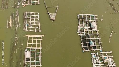 Aerial drone of traditional fishing on the river and a fish farm. Hinigaran River. Negros, Philippines photo