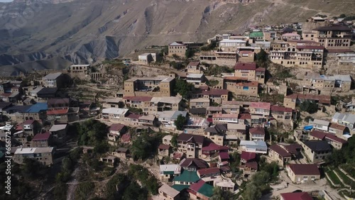 Aerial view village Choh residential buildings gorgeous summer caucasus mountains ridge valley. Old houses in countryside on rocky slopes. Flying over scenery nature wild landscape small rural town 4 photo