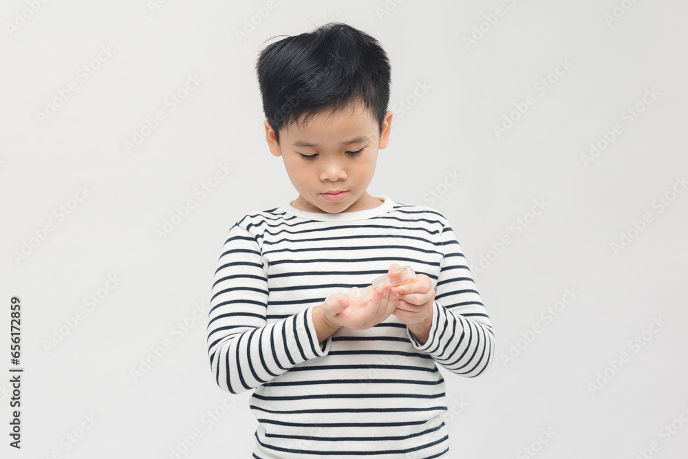 Banner of a school boy applying alcohol gel to make cleaning and clear germ, bacteria in hand Banner of a school boy applying alcohol gel to make cleaning and clear germ, bacteria in hand