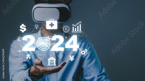2024 planning,health and goals concept.Business man using Virtual Reality Glasses and creative New Goals and Visions for New Year 2024.life,medical,opportunity, challenge and target concept.